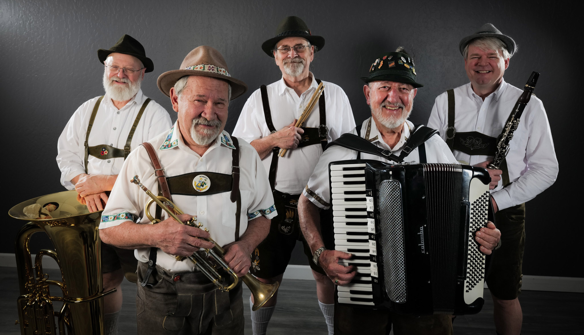 Five members of the Crackerjack Polka band, holding their instruments