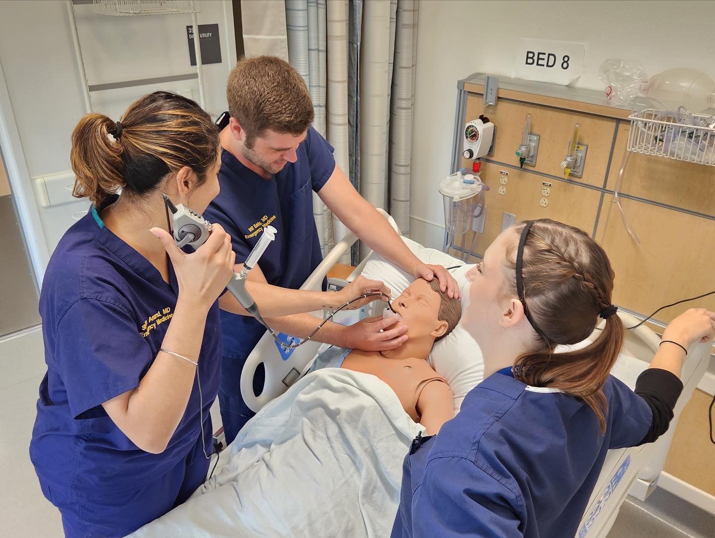Students working on a mannequin at the UCDH Simulation Center.