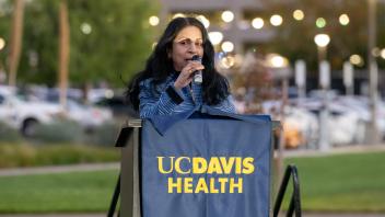 UC Tech managing sponsor, Viji Murali, speaking on a UC Davis Health podium.