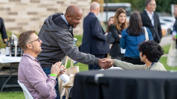 Two attendees shaking hands