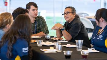 Attendees talking around a table