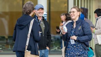 Attendees smiling at each other.