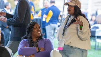 Two attendees having a conversation.