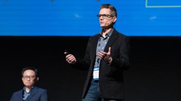 UC Tech session presenter speaking on stage