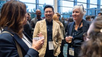 Attendees talking at the Monday evening reception at UC Tech
