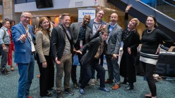 UC Tech attendees, including UC CIOs, do a funny pose in a group photo at the Monday evening reception at UC Tech