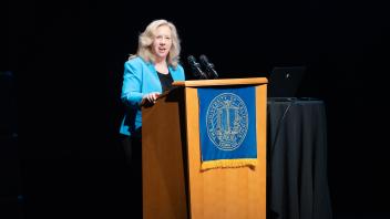 UC Davis Provost, Mary Croughan, speaking on the podium.