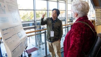UC Tech poster presenter speaking on their poster presentation