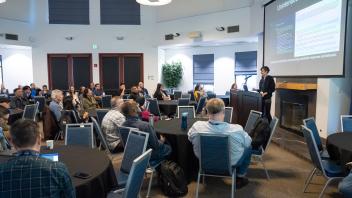 UC Tech session presenter speaking on stage
