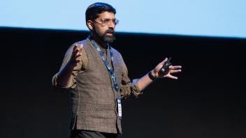 UC Tech session presenter speaking on stage