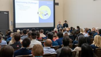 UC Tech session presenter speaking on stage