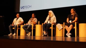 Accessibility panel sitting in a row with a presentation slide in the background.