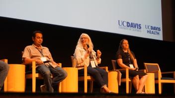 Accessibility panel sitting in a row with a presentation slide in the background.