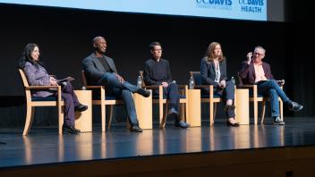 CIO panel sitting in a row with a presentation slide in the background.