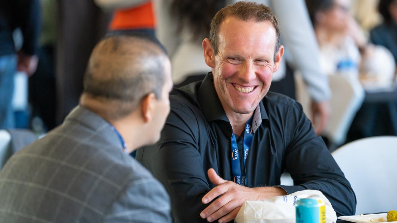 Attendee smiling at another attendee