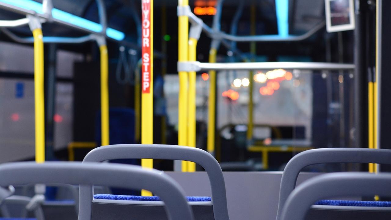 Image inside of a bus, showing seats.