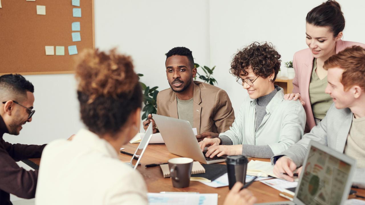 Group of people in a meeting together.