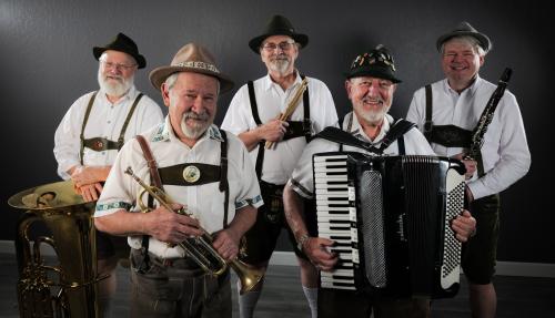 Five members of the Crackerjack Polka band, holding their instruments