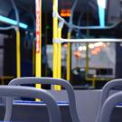 Image inside of a bus, showing seats.
