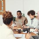Group of people in a meeting together.